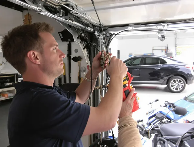 Heath Garage Door Repair safety certified technician performing cable replacement in Heath